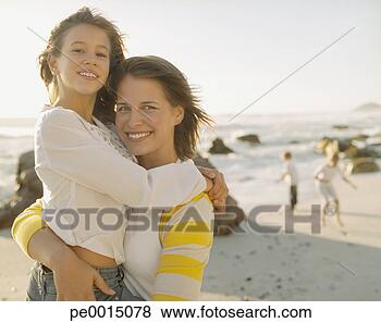 Stock Photo - mother embracing 
young daughter 
on a beach. fotosearch 
- search stock 
photos, pictures, 
images, and photo 
clipart