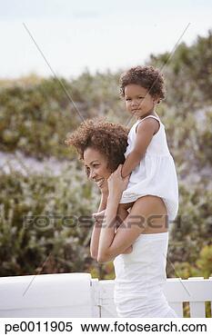 Stock Image - mother giving 
daughter shoulder 
ride. fotosearch 
- search stock 
photos, pictures, 
images, and photo 
clipart
