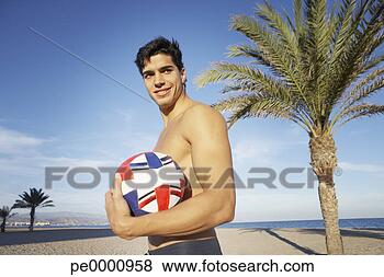 Stock Photo - man on a beach 
holding a volleyball. 
fotosearch - search 
stock photos, 
pictures, images, 
and photo clipart