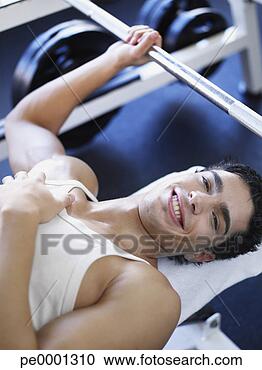 Stock Photography - man on a bench 
getting ready 
to lift free weights. 
fotosearch - search 
stock photos, 
pictures, images, 
and photo clipart