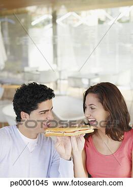 Stock Image - young couple sharing 
a deli sandwich. 
fotosearch - search 
stock photos, 
pictures, images, 
and photo clipart