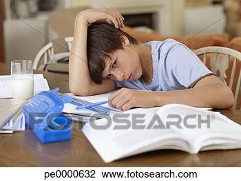 Stock Photo - boy sitting at 
table doing homework. 
fotosearch - search 
stock photos, 
pictures, images, 
and photo clipart