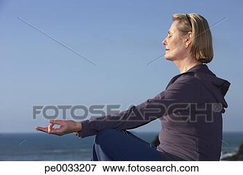 Picture - senior woman doing 
yoga outdoors. 
fotosearch - search 
stock photos, 
pictures, images, 
and photo clipart