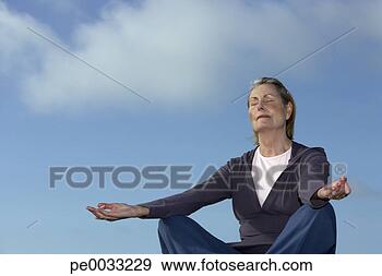Stock Photograph - senior woman doing 
yoga outdoors. 
fotosearch - search 
stock photos, 
pictures, images, 
and photo clipart
