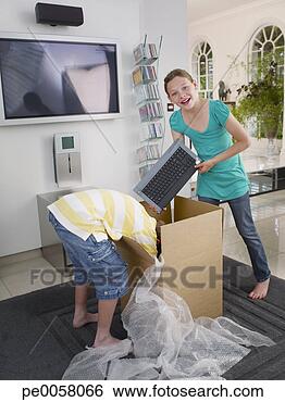 Stock Photo - young boy and 
girl opening box 
with computer 
inside. fotosearch 
- search stock 
photos, pictures, 
images, and photo 
clipart
