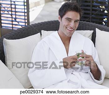 Stock Photo - man in a bathrobe 
holding a healthy 
beverage. fotosearch 
- search stock 
photos, pictures, 
images, and photo 
clipart