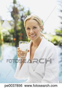Stock Photo - woman relaxing 
in a bathrobe 
by a pool. fotosearch 
- search stock 
photos, pictures, 
images, and photo 
clipart
