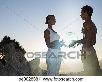 Picture - a man and woman 
holding an orb. 
fotosearch - search 
stock photos, 
pictures, images, 
and photo clipart