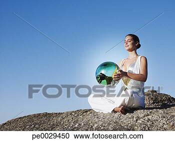 Stock Photography - a woman holding 
an orb. fotosearch 
- search stock 
photos, pictures, 
images, and photo 
clipart