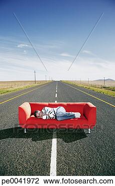 Stock Photo - a man sleeping 
on a couch in 
the road. fotosearch 
- search stock 
photos, pictures, 
images, and photo 
clipart