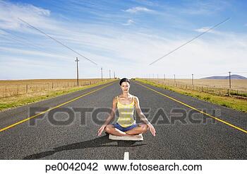 Stock Photo - a woman doing 
yoga in the middle 
of the road. fotosearch 
- search stock 
photos, pictures, 
images, and photo 
clipart