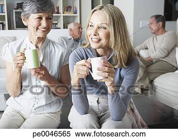 Stock Image - friends hanging 
out in a living 
room. fotosearch 
- search stock 
photos, pictures, 
images, and photo 
clipart