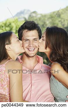 Stock Photograph - a young man with 
two young woman 
embracing him. 
fotosearch - search 
stock photos, 
pictures, images, 
and photo clipart