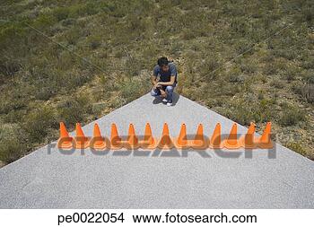Stock Photo - man cornered by 
a row of safety 
cones. fotosearch 
- search stock 
photos, pictures, 
images, and photo 
clipart
