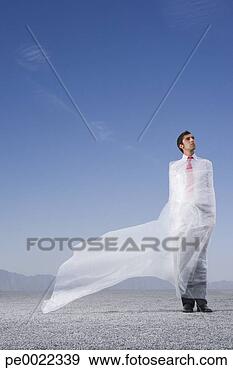 Stock Photograph - man outdoors ensnared 
in a sheer sheet. 
fotosearch - search 
stock photos, 
pictures, images, 
and photo clipart