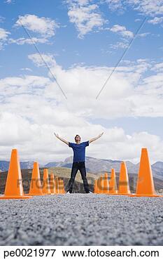 Picture - man with outstretched 
arms standing 
in-between two 
rows of safety. 
fotosearch - search 
stock photos, 
pictures, images, 
and photo clipart