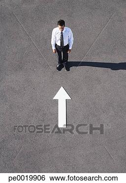 Stock Photo - arrow on pavement 
pointing toward 
businessman. fotosearch 
- search stock 
photos, pictures, 
images, and photo 
clipart
