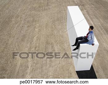Picture - businessman sitting 
on block outdoors. 
fotosearch - search 
stock photos, 
pictures, images, 
and photo clipart