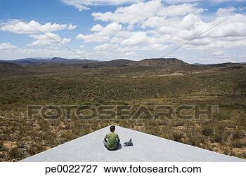 Picture - man sitting on 
a corner with 
his laptop computer. 
fotosearch - search 
stock photos, 
pictures, images, 
and photo clipart