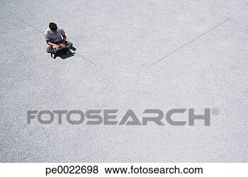 Stock Photo - man sitting on 
the ground working 
on his laptop 
computer. fotosearch 
- search stock 
photos, pictures, 
images, and photo 
clipart