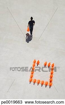 Stock Photo - man walking away 
from box of traffic 
cones with one. 
fotosearch - search 
stock photos, 
pictures, images, 
and photo clipart