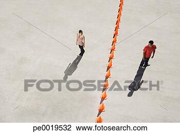 Stock Photo - man and woman 
on either side 
of row of traffic 
cones looking 
back. fotosearch 
- search stock 
photos, pictures, 
images, and photo 
clipart