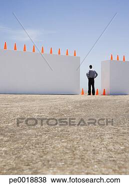 Stock Photo - businessman standing 
between two walls 
outdoors with 
traffic cones. 
fotosearch - search 
stock photos, 
pictures, images, 
and photo clipart