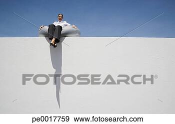 Stock Photograph - businesswoman 
sitting on beanbag 
chair on wall 
outdoors. fotosearch 
- search stock 
photos, pictures, 
images, and photo 
clipart