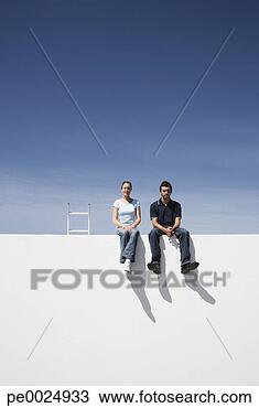 Stock Photo - man and woman 
on wall outdoors 
with ladder. fotosearch 
- search stock 
photos, pictures, 
images, and photo 
clipart