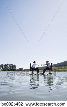 Stock Photo - businessman and 
woman in office 
chairs on water 
shaking hands. 
fotosearch - search 
stock photos, 
pictures, images, 
and photo clipart