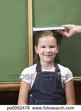 Stock Photo - a student being 
measured in front 
a chalkboard. 
fotosearch - search 
stock photos, 
pictures, images, 
and photo clipart
