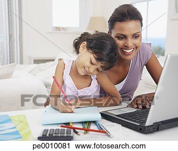 Stock Photography - mother at laptop 
with daughter 
drawing. fotosearch 
- search stock 
photos, pictures, 
images, and photo 
clipart