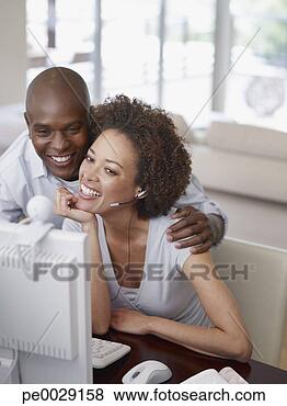 Stock Photo - a couple at a 
computer. fotosearch 
- search stock 
photos, pictures, 
images, and photo 
clipart