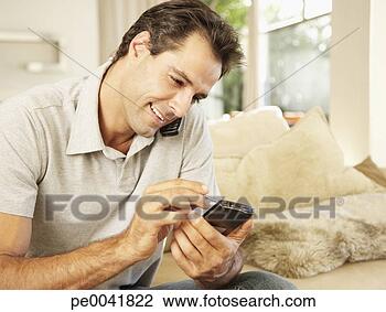 Stock Photo - man on a cellular 
using a personal 
digital assistant. 
fotosearch - search 
stock photos, 
pictures, images, 
and photo clipart