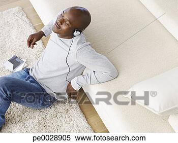 Stock Image - man listening 
to music wearing 
headphones. fotosearch 
- search stock 
photos, pictures, 
images, and photo 
clipart