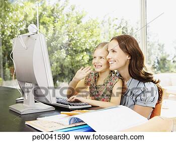 Stock Photography - a mother using 
a computer with 
her daughter. 
fotosearch - search 
stock photos, 
pictures, images, 
and photo clipart