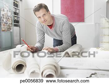 Stock Photograph - architect working 
on drafts in office. 
fotosearch - search 
stock photos, 
pictures, images, 
and photo clipart
