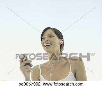 Stock Photo - a woman listening 
to music. fotosearch 
- search stock 
photos, pictures, 
images, and photo 
clipart