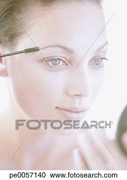 Stock Photography - a woman applying 
make-up. fotosearch 
- search stock 
photos, pictures, 
images, and photo 
clipart