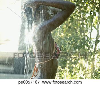 Picture - a woman showering 
after swimming. 
fotosearch - search 
stock photos, 
pictures, images, 
and photo clipart