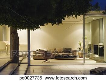 Stock Image - modern living 
room and patio 
with sliding glass 
walls. fotosearch 
- search stock 
photos, pictures, 
images, and photo 
clipart