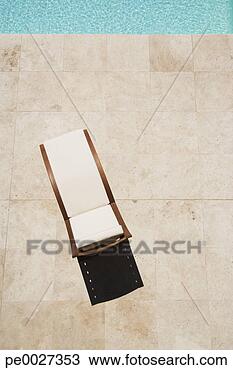 Stock Photo - poolside empty 
lounge chair from 
a high angle view. 
fotosearch - search 
stock photos, 
pictures, images, 
and photo clipart