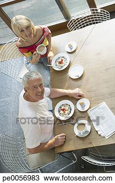 Stock Photo - couple at table 
with breakfast 
and newspaper. 
fotosearch - search 
stock photos, 
pictures, images, 
and photo clipart