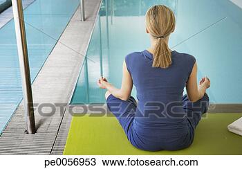 Stock Photo - woman doing yoga 
by an indoor pool. 
fotosearch - search 
stock photos, 
pictures, images, 
and photo clipart
