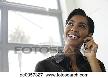 Picture - businesswoman 
on her mobile 
phone in office. 
fotosearch - search 
stock photos, 
pictures, images, 
and photo clipart