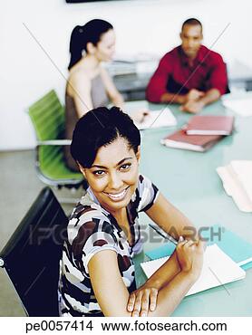 Stock Photo - businesswoman 
at table in office 
with two coworkers 
in background. 
fotosearch - search 
stock photos, 
pictures, images, 
and photo clipart