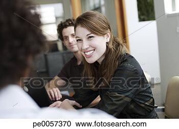 Stock Photography - three businesspeople 
in an office working. 
fotosearch - search 
stock photos, 
pictures, images, 
and photo clipart