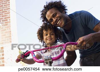 Stock Photo - father teaching 
daughter to ride 
bicycle in driveway. 
fotosearch - search 
stock photos, 
pictures, images, 
and photo clipart
