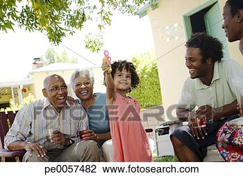 Stock Photo - girl blowing bubbles 
with two couples 
around her. fotosearch 
- search stock 
photos, pictures, 
images, and photo 
clipart