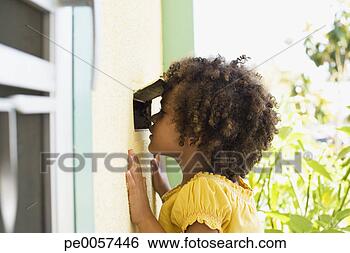 Stock Photo - girl peeking through 
a mail slot in 
door. fotosearch 
- search stock 
photos, pictures, 
images, and photo 
clipart